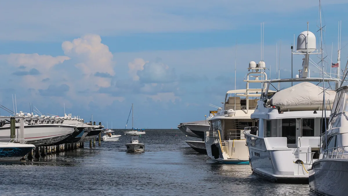 Luxury yachts at a Miami marina — real-world wealth imagery, not in-game.